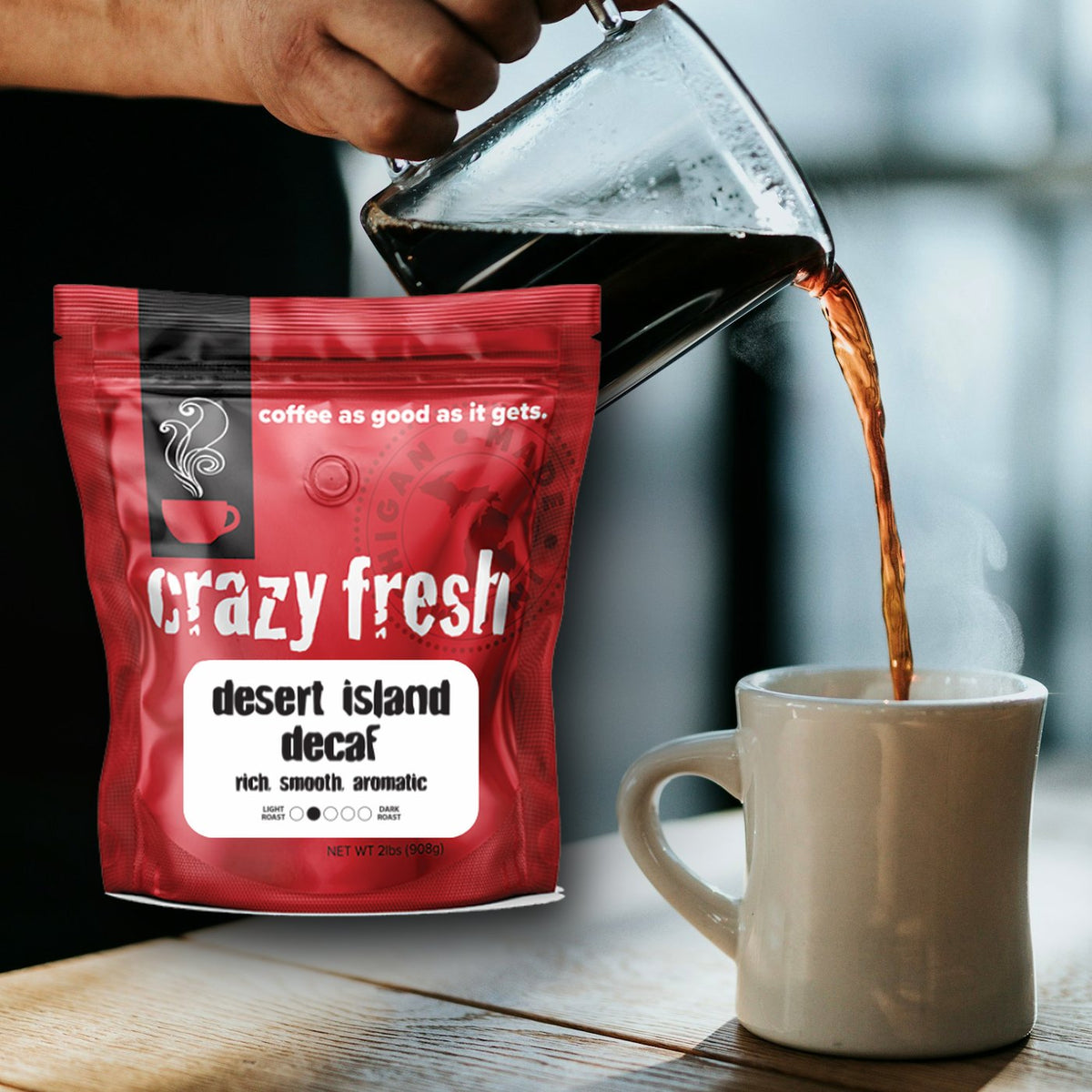 Crazy Fresh Desert Island Decaf with coffee pouring from a carafe into a mug